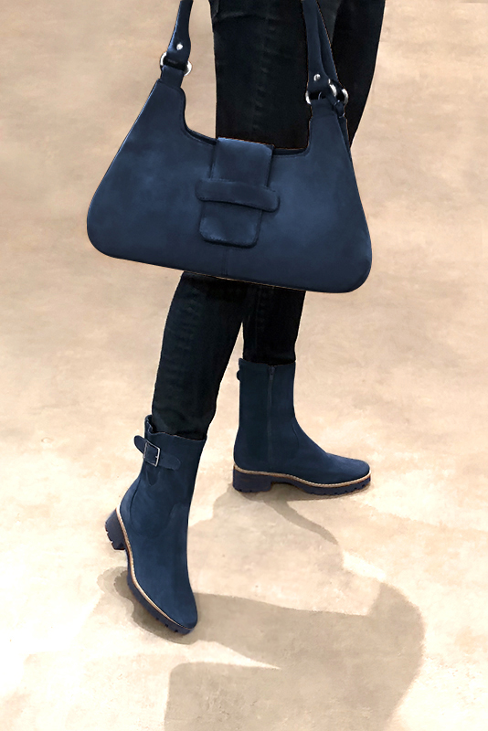 Navy blue women's ankle boots with buckles on the sides. Round toe. Low rubber soles. Worn view - Florence KOOIJMAN